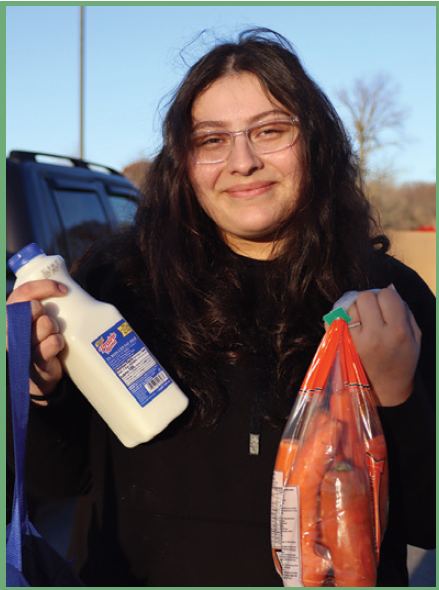 Single mom, Melissa smiling holding groceries